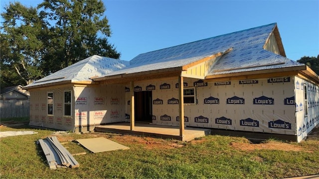 rear view of property with a yard