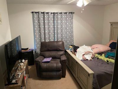 bedroom featuring light carpet and ceiling fan