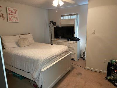 bedroom with light carpet and ceiling fan