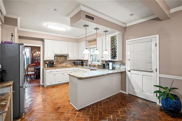 kitchen with pendant lighting, kitchen peninsula, stainless steel appliances, and plenty of natural light