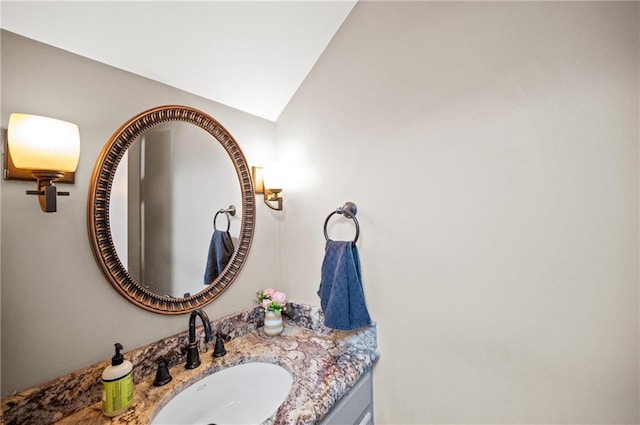 bathroom featuring vanity and vaulted ceiling