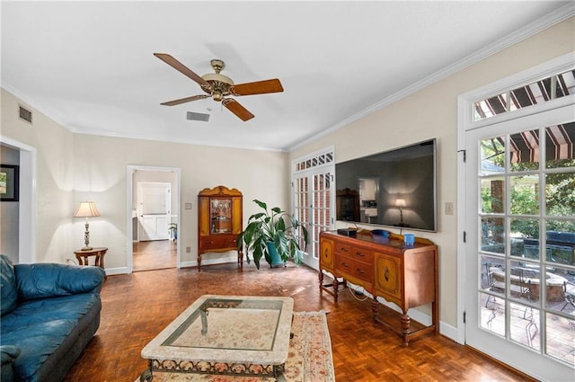 living room featuring ornamental molding, dark parquet flooring, and ceiling fan