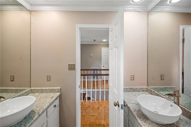 bathroom with vanity, crown molding, and parquet floors