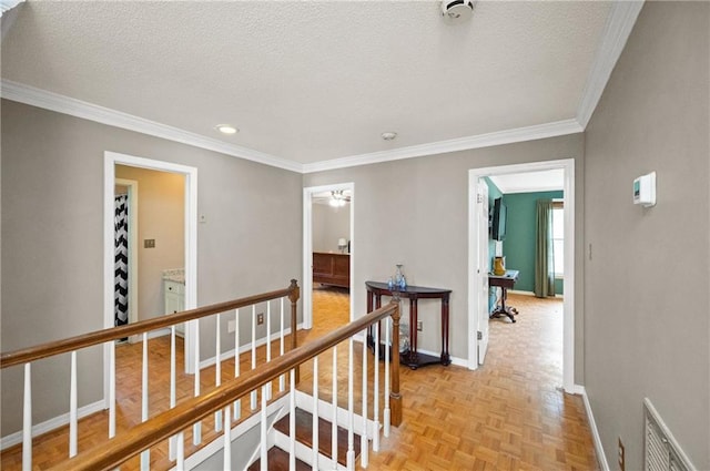 hallway featuring crown molding, light parquet flooring, and a textured ceiling