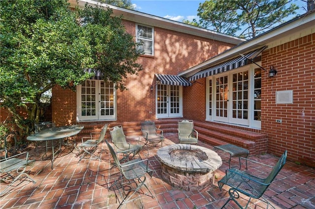 view of patio featuring french doors and a fire pit