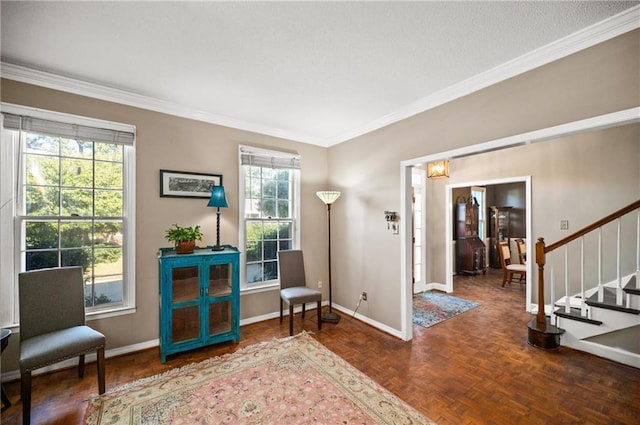 sitting room featuring a healthy amount of sunlight, ornamental molding, and dark parquet flooring