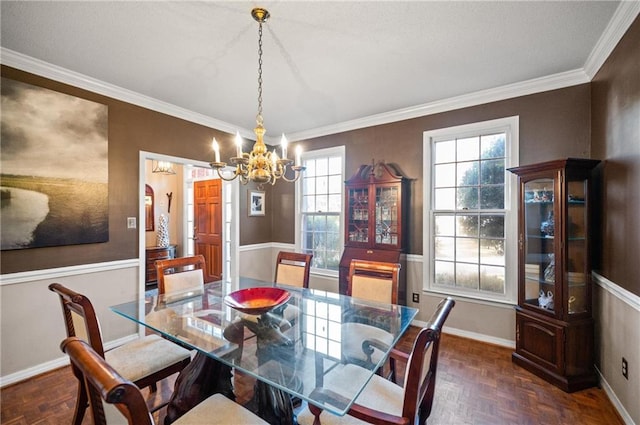 dining space featuring crown molding, dark parquet floors, and an inviting chandelier