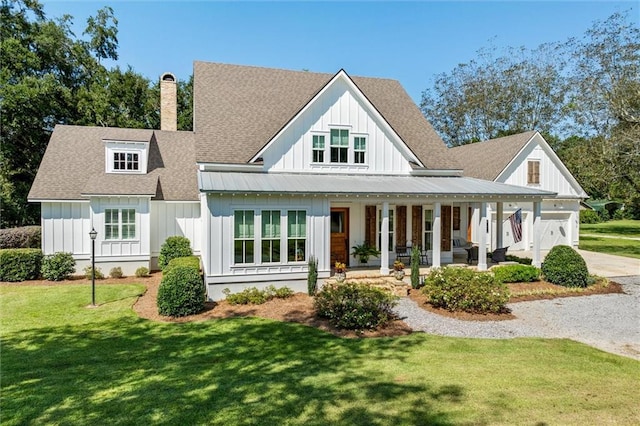 back of property with a lawn and covered porch