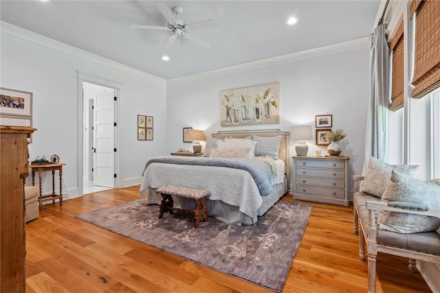 bedroom featuring ceiling fan, light hardwood / wood-style flooring, and ornamental molding