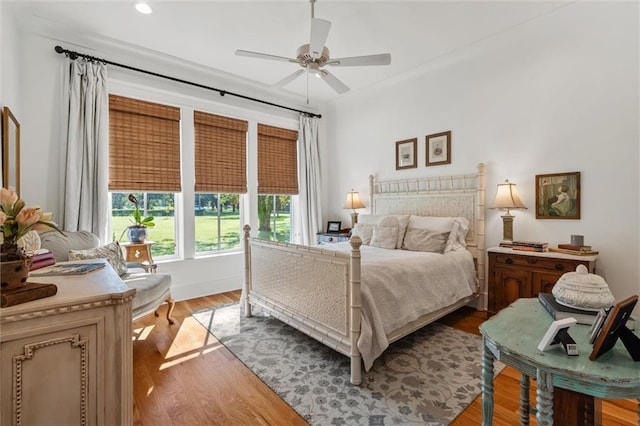 bedroom with light hardwood / wood-style flooring and ceiling fan