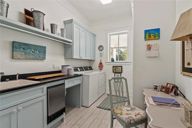 kitchen featuring ornamental molding, sink, gray cabinets, light wood-type flooring, and washer and dryer