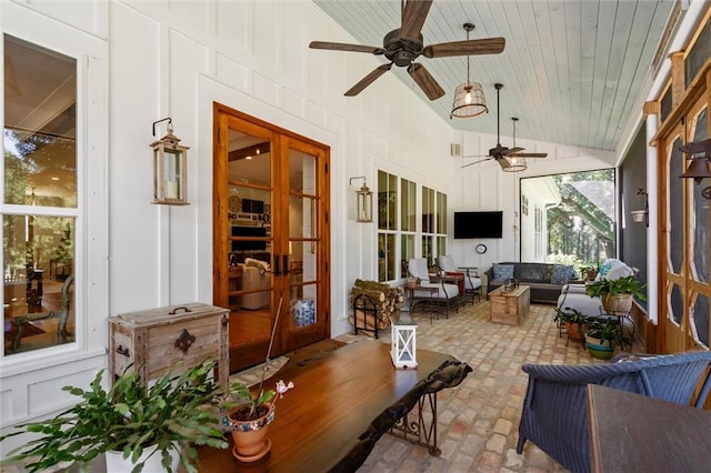 sunroom / solarium with vaulted ceiling, ceiling fan, and wooden ceiling