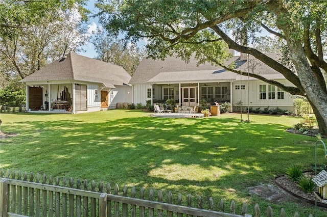 rear view of property featuring a lawn and a patio