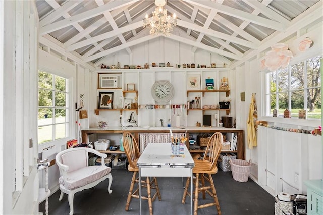 interior space featuring an inviting chandelier, vaulted ceiling, an AC wall unit, and a healthy amount of sunlight