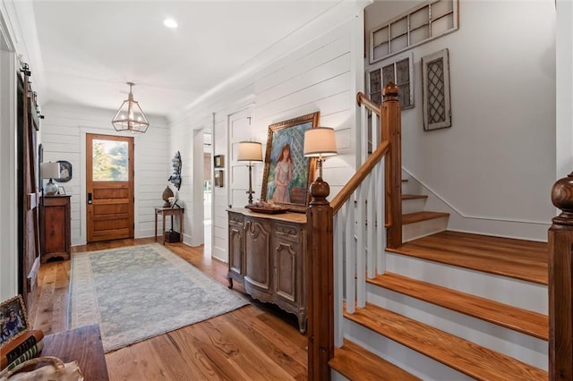 foyer featuring light wood-type flooring and an inviting chandelier