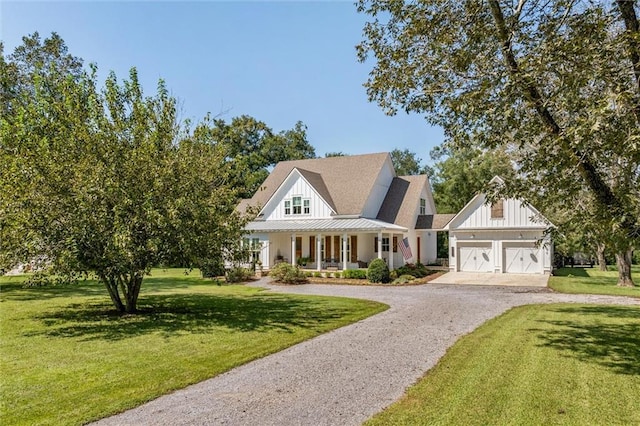 view of front of home featuring a garage, a front lawn, and a porch