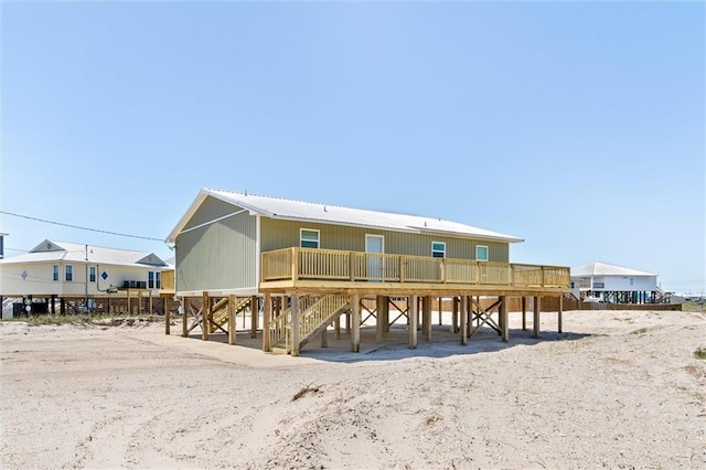 109 Quebec Ct, Dauphin Island, AL 36528 - rear view of property featuring stairs and metal roof