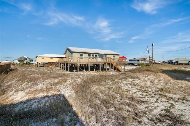 109 Quebec Ct, Dauphin Island, AL 36528 - rear view of property with stairway and a wooden deck
