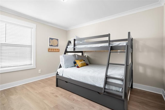109 Quebec Ct, Dauphin Island, AL 36528 - bedroom with ornamental molding, wood finished floors, and baseboards