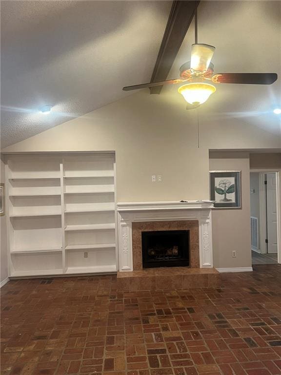 unfurnished living room with brick flooring, a ceiling fan, baseboards, and a premium fireplace