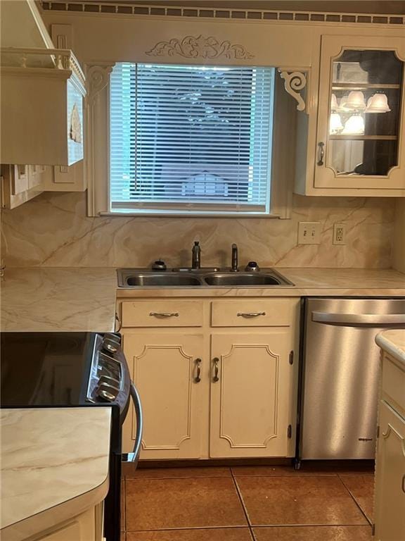 kitchen with dishwasher, a sink, range, and light countertops