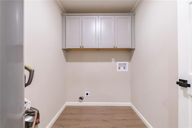 laundry area with cabinets, hookup for a washing machine, electric dryer hookup, and crown molding