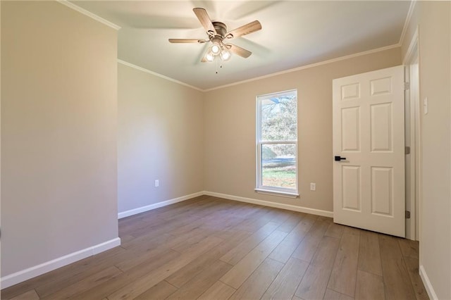 empty room featuring light hardwood / wood-style floors, ceiling fan, and crown molding