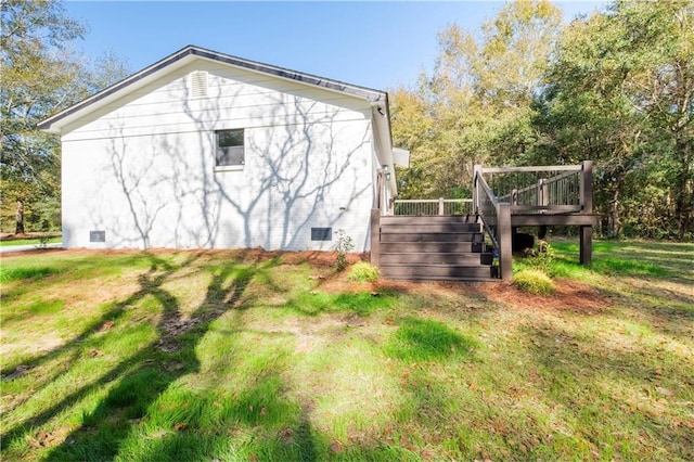 view of side of home with a lawn and a wooden deck