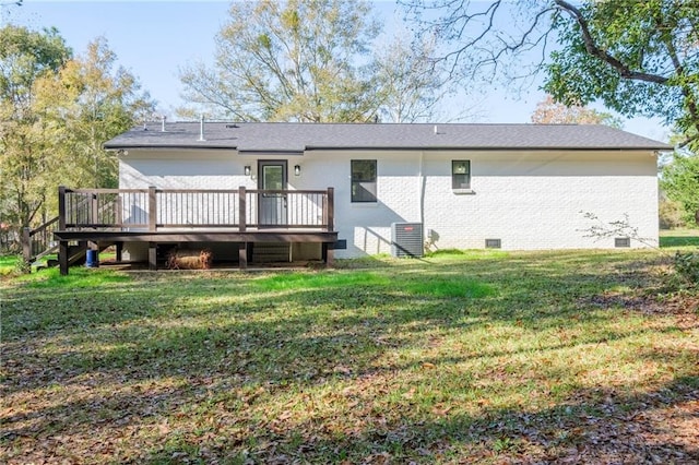 back of house featuring a lawn, central air condition unit, and a wooden deck