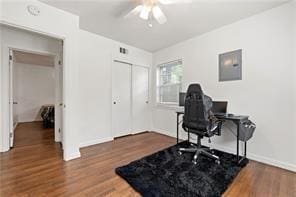 office space with baseboards, ceiling fan, wood finished floors, and electric panel