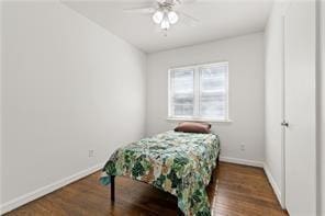 bedroom with baseboards, ceiling fan, and wood finished floors