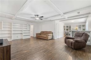 living area with coffered ceiling, beamed ceiling, a ceiling fan, built in features, and wood finished floors
