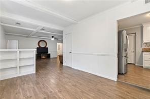 unfurnished room featuring ornamental molding and wood finished floors