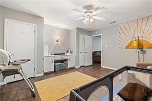 interior space featuring baseboards, wood finished floors, and a ceiling fan