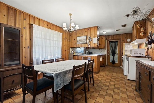 2950 Pinetucky Rd, Mobile, AL 36618 - dining space featuring a chandelier and wood walls