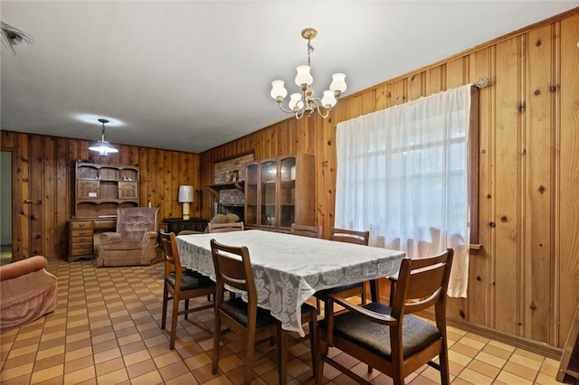 2950 Pinetucky Rd, Mobile, AL 36618 - dining space featuring wood walls and a chandelier