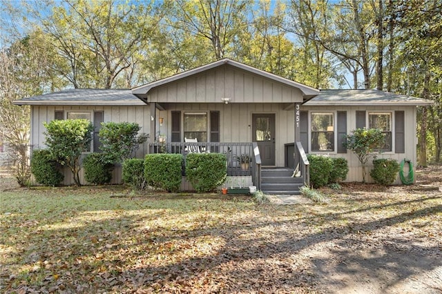 ranch-style house featuring a porch and a front lawn