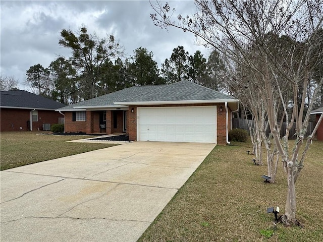 ranch-style home featuring cooling unit, a garage, and a front lawn