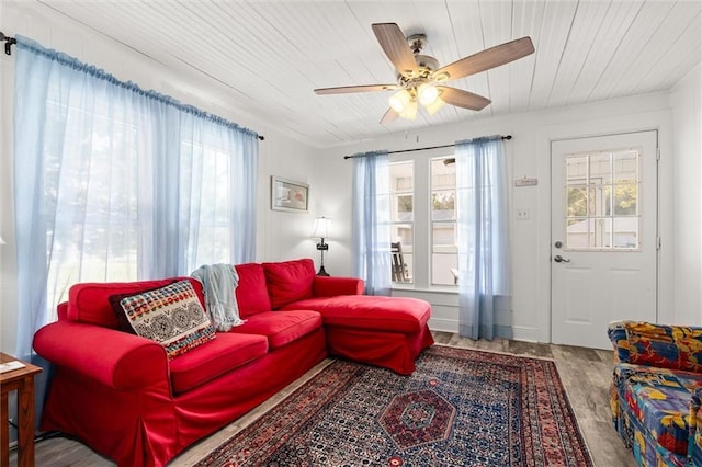 living area featuring wood ceiling, wood finished floors, and a ceiling fan