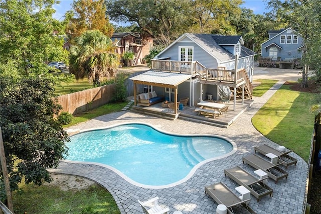 view of pool featuring a deck, a yard, and a patio area