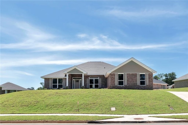 view of front facade featuring a front lawn and brick siding