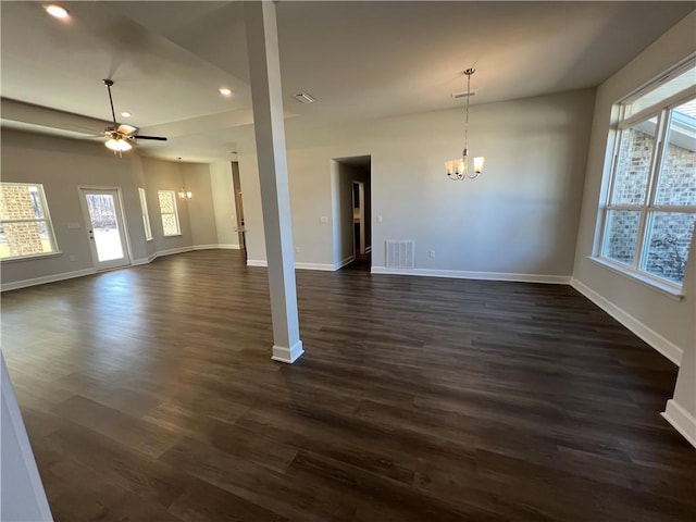 interior space with baseboards, visible vents, dark wood-type flooring, and ceiling fan with notable chandelier