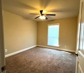 empty room featuring ceiling fan and carpet