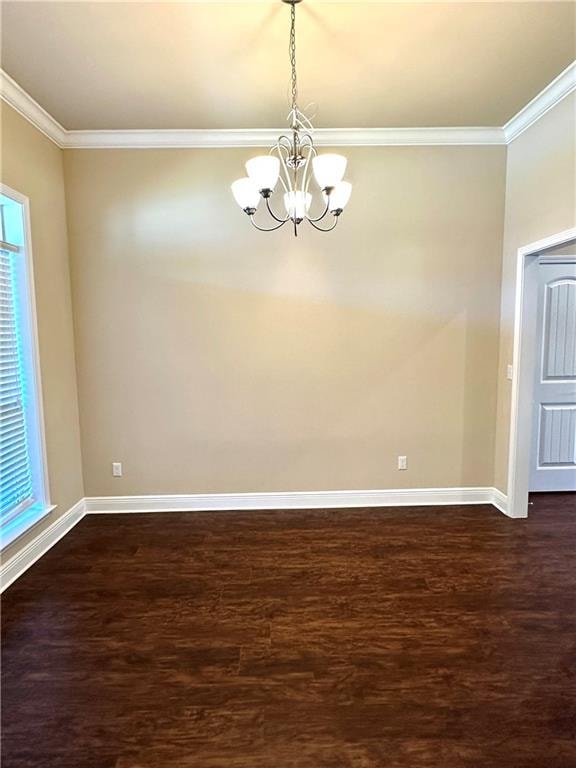 spare room featuring ornamental molding, dark hardwood / wood-style flooring, and a chandelier