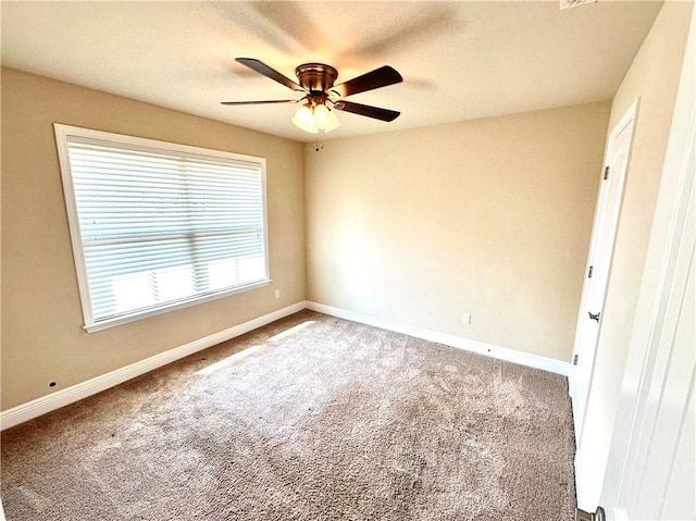 unfurnished room featuring ceiling fan and carpet