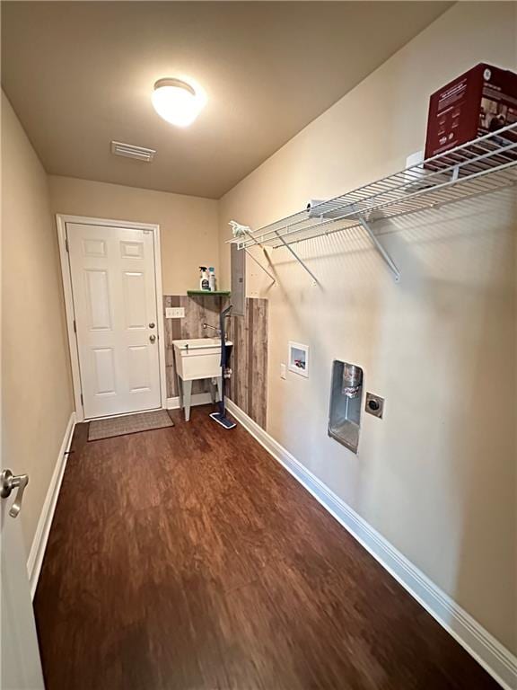 clothes washing area with hookup for a washing machine, dark hardwood / wood-style floors, and hookup for an electric dryer