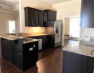 kitchen with kitchen peninsula, a breakfast bar, stainless steel fridge with ice dispenser, and dark wood-type flooring