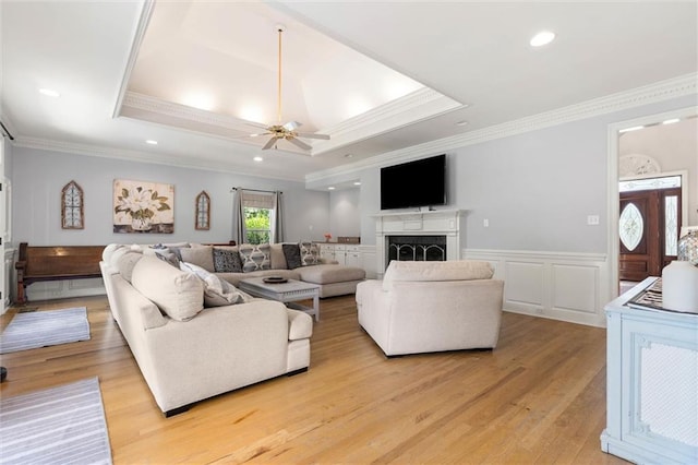 704 Providence Estates Dr E, Mobile, AL 36695 - living area featuring crown molding, wainscoting, ceiling fan, light wood-style floors, and a fireplace