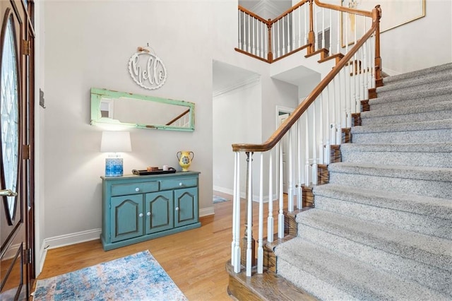 704 Providence Estates Dr E, Mobile, AL 36695 - foyer featuring baseboards, stairs, light wood-style floors, and a high ceiling