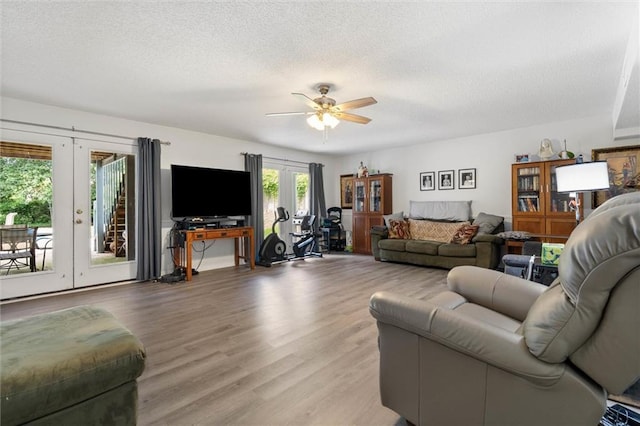 704 Providence Estates Dr E, Mobile, AL 36695 - living area featuring french doors, ceiling fan, light wood-style flooring, and a textured ceiling